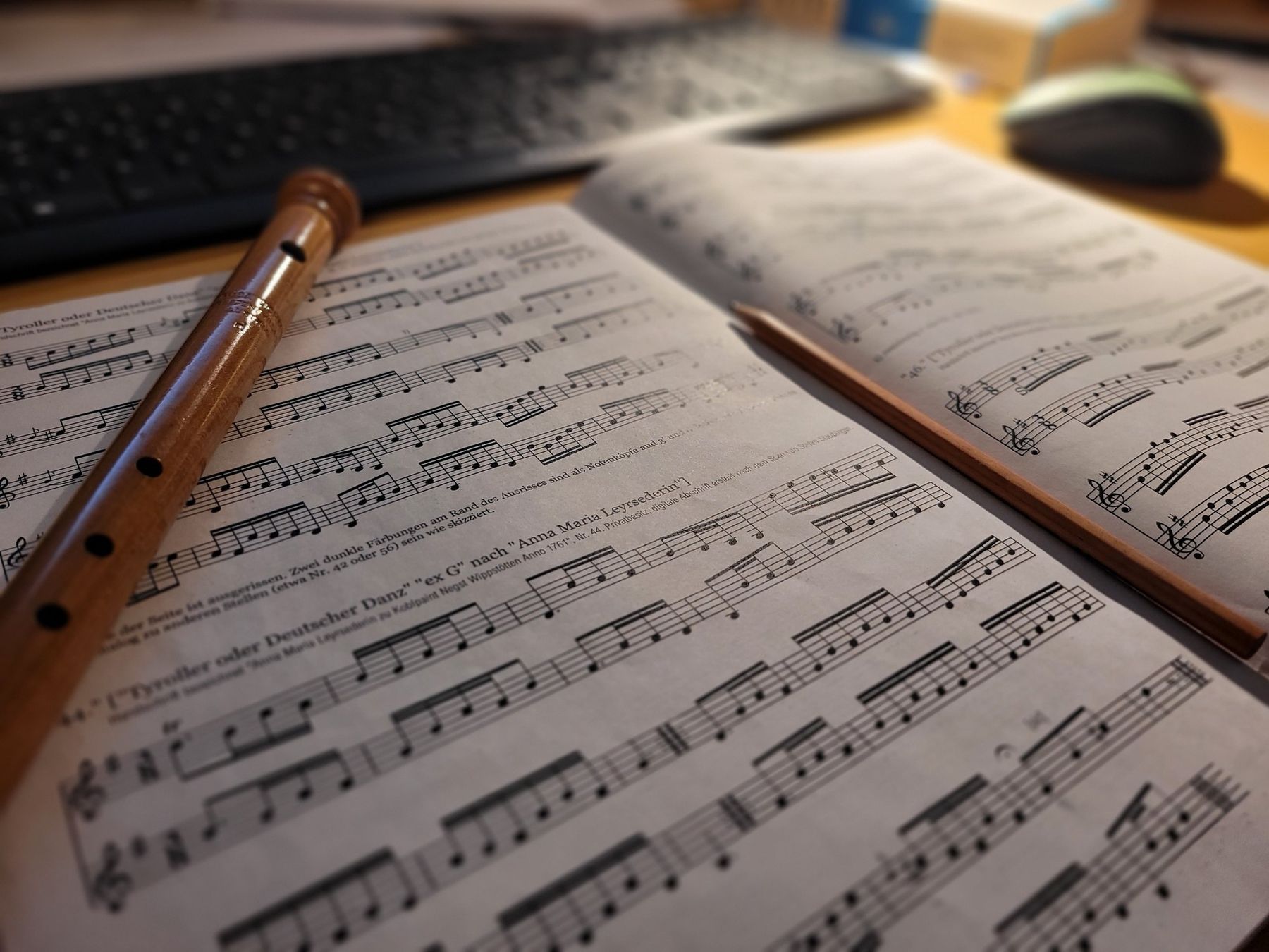 Notenblätter, Blockflöte und Bleistift auf dem Schreibtisch